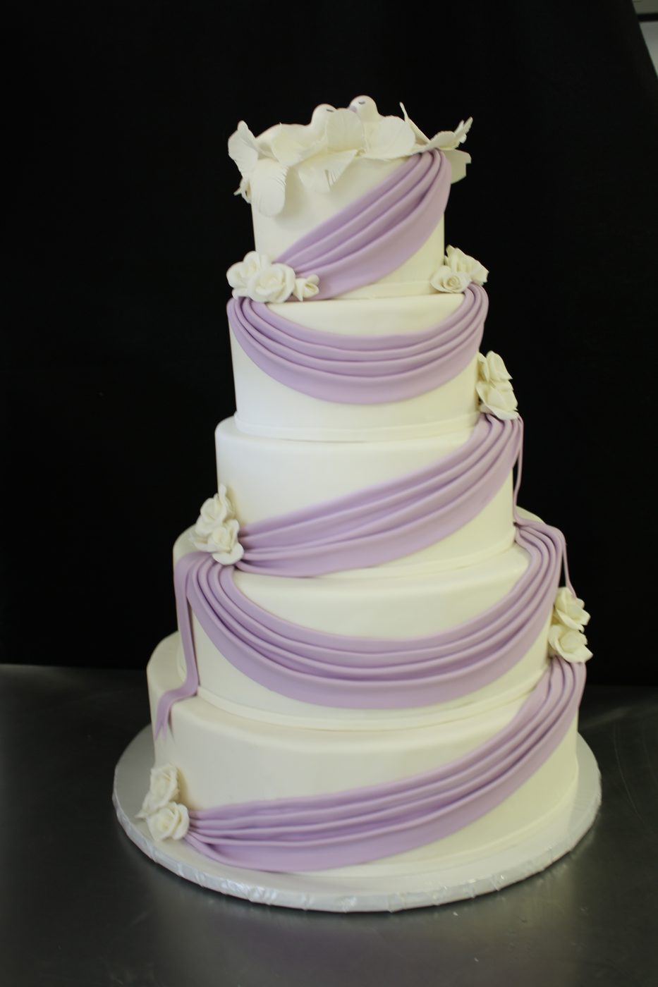 Wedding cake with lavender fondant swags